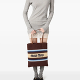 Brown bag carried by a person, showing the bag fit