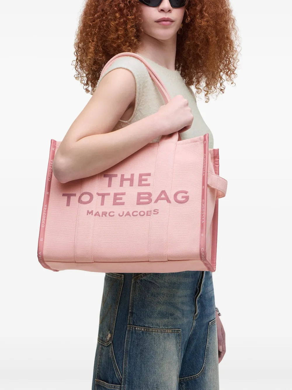 Pink bag, worn by a person, showing the bag's fit