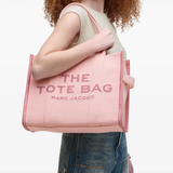 Pink bag, worn by a person, showing the bag's fit