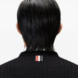 Black knitwear worn by a person, showing the knitwear fit