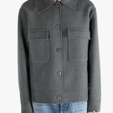 Grey jacket worn by a person, showing the pants fit