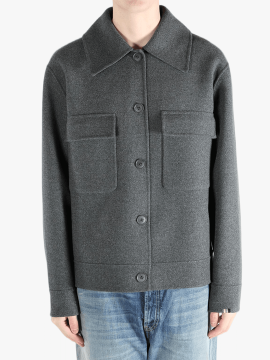 Grey jacket worn by a person, showing the pants fit