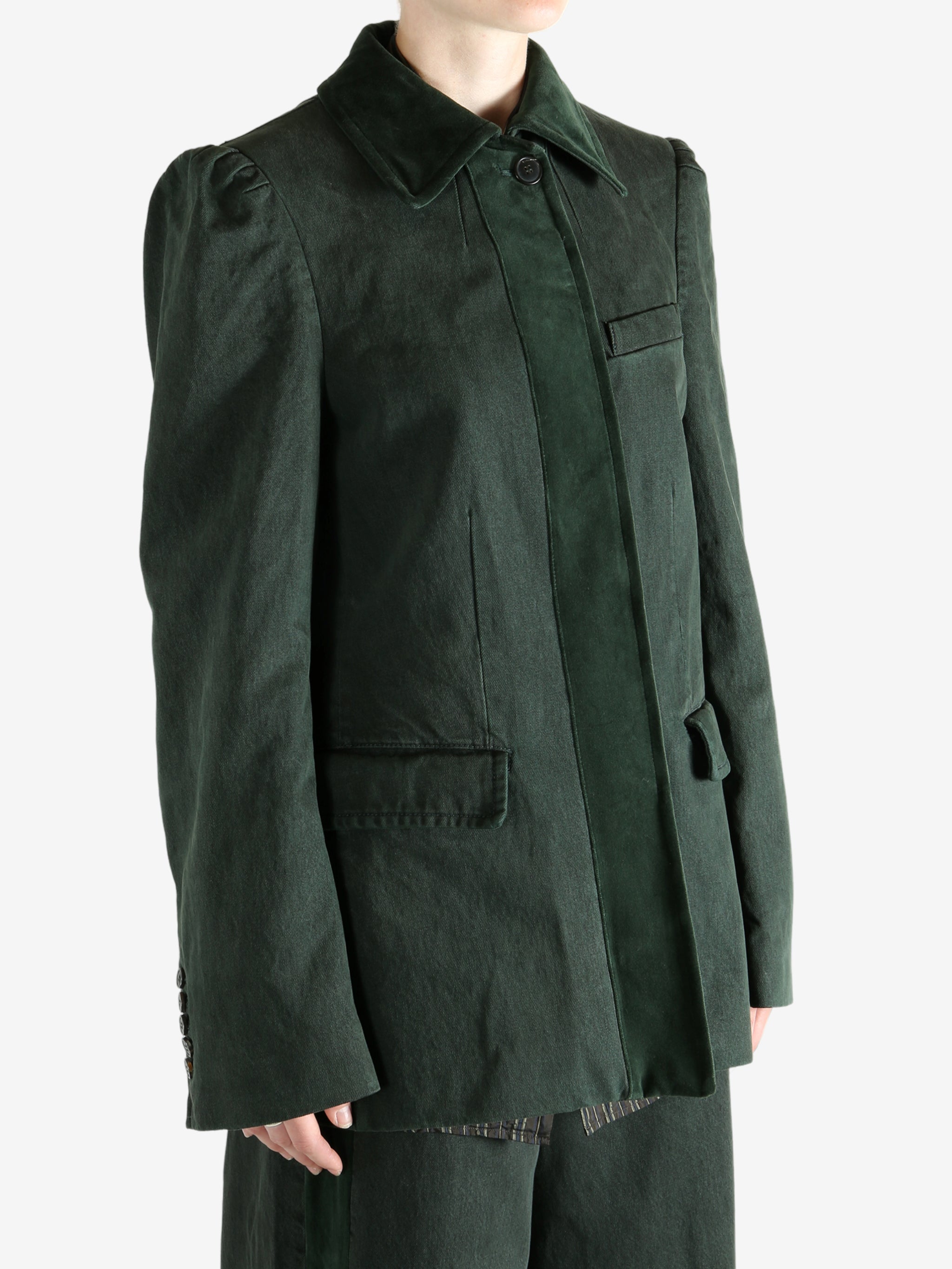 Green jacket worn by a person, showing the jacket's fit