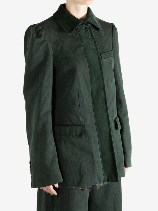 Green jacket worn by a person, showing the jacket's fit