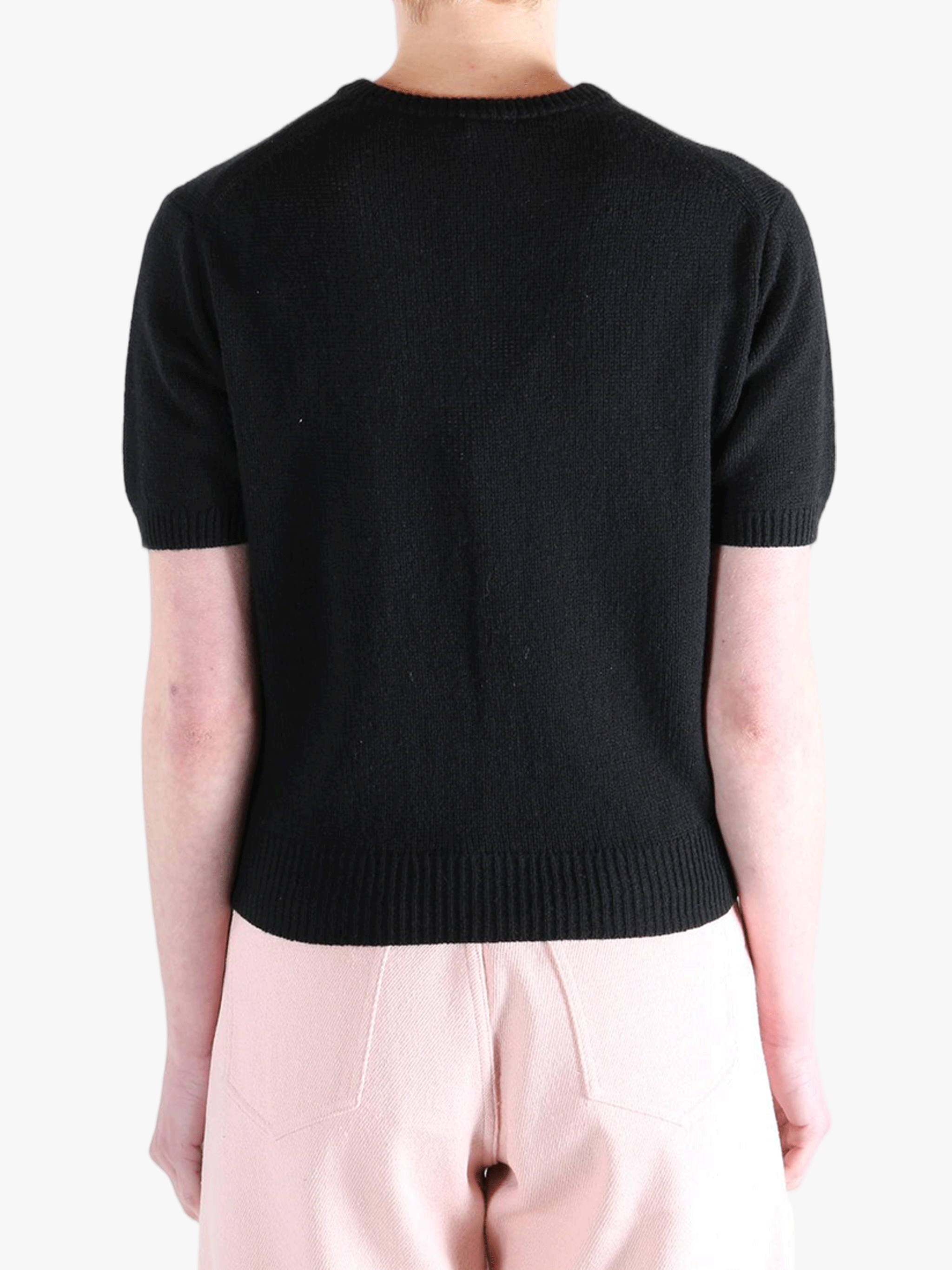 Black knitwear worn by a person, showing the knitwear's fit