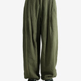 Green pants worn by a person, showing the pants' fit