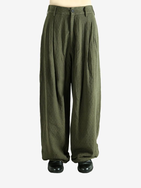 Green pants worn by a person, showing the pants' fit