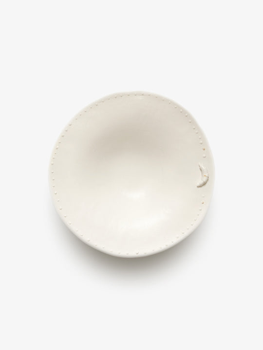 JINJIN PARIS Croissant Shallow Bowl in ivory porcelain, top view showing organic shape and dotted edge.