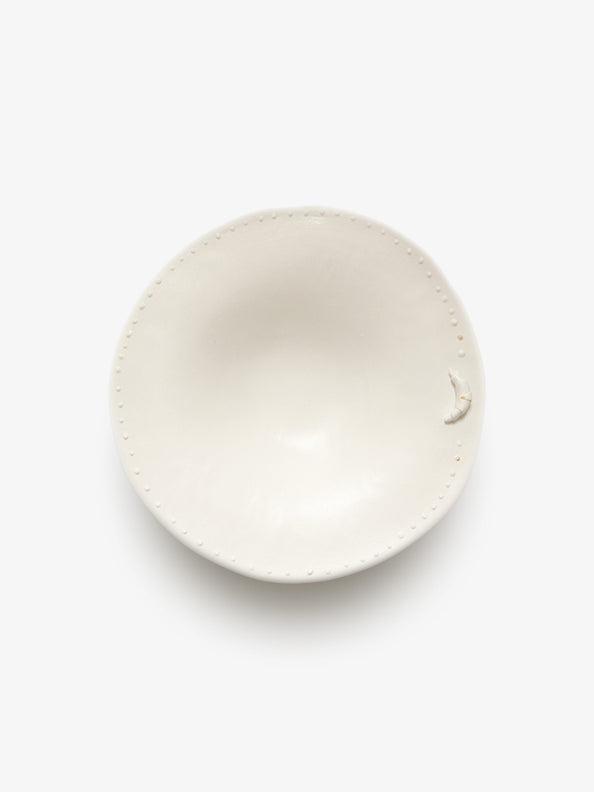JINJIN PARIS Croissant Shallow Bowl in ivory porcelain, top view showing organic shape and dotted edge.