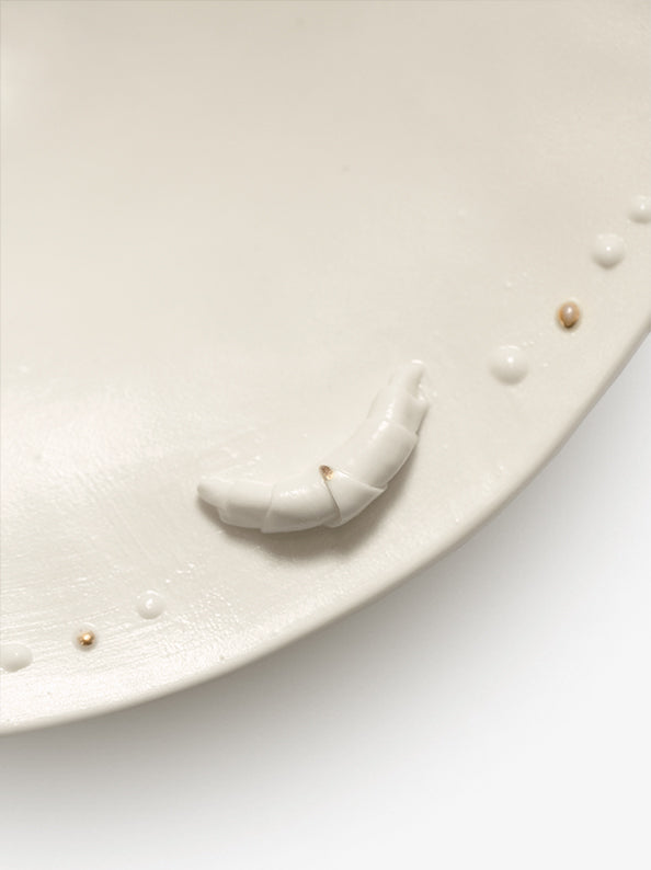 JINJIN PARIS Croissant Shallow Bowl detail with sculpted croissant accent and raised porcelain bead trim.