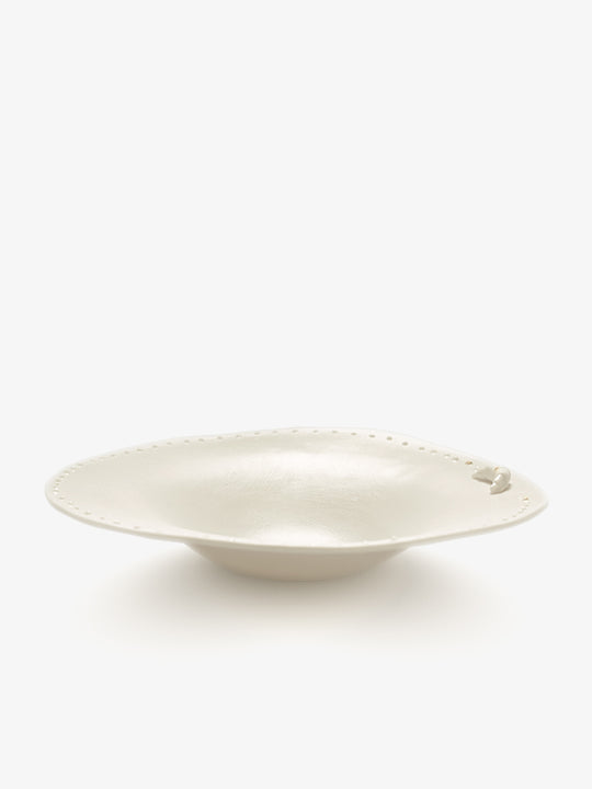 JINJIN PARIS Croissant Shallow Bowl in ivory porcelain, angled view with croissant detail and dotted rim.