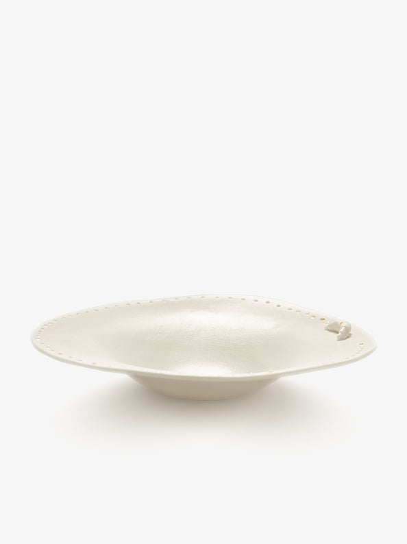 JINJIN PARIS Croissant Shallow Bowl in ivory porcelain, angled view with croissant detail and dotted rim.