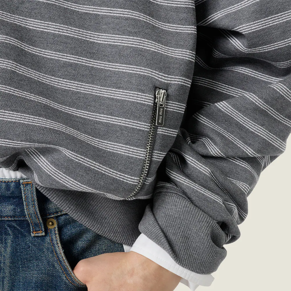 Tan knitwear worn by a person, showing the knitwear fit