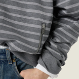 Tan knitwear worn by a person, showing the knitwear fit