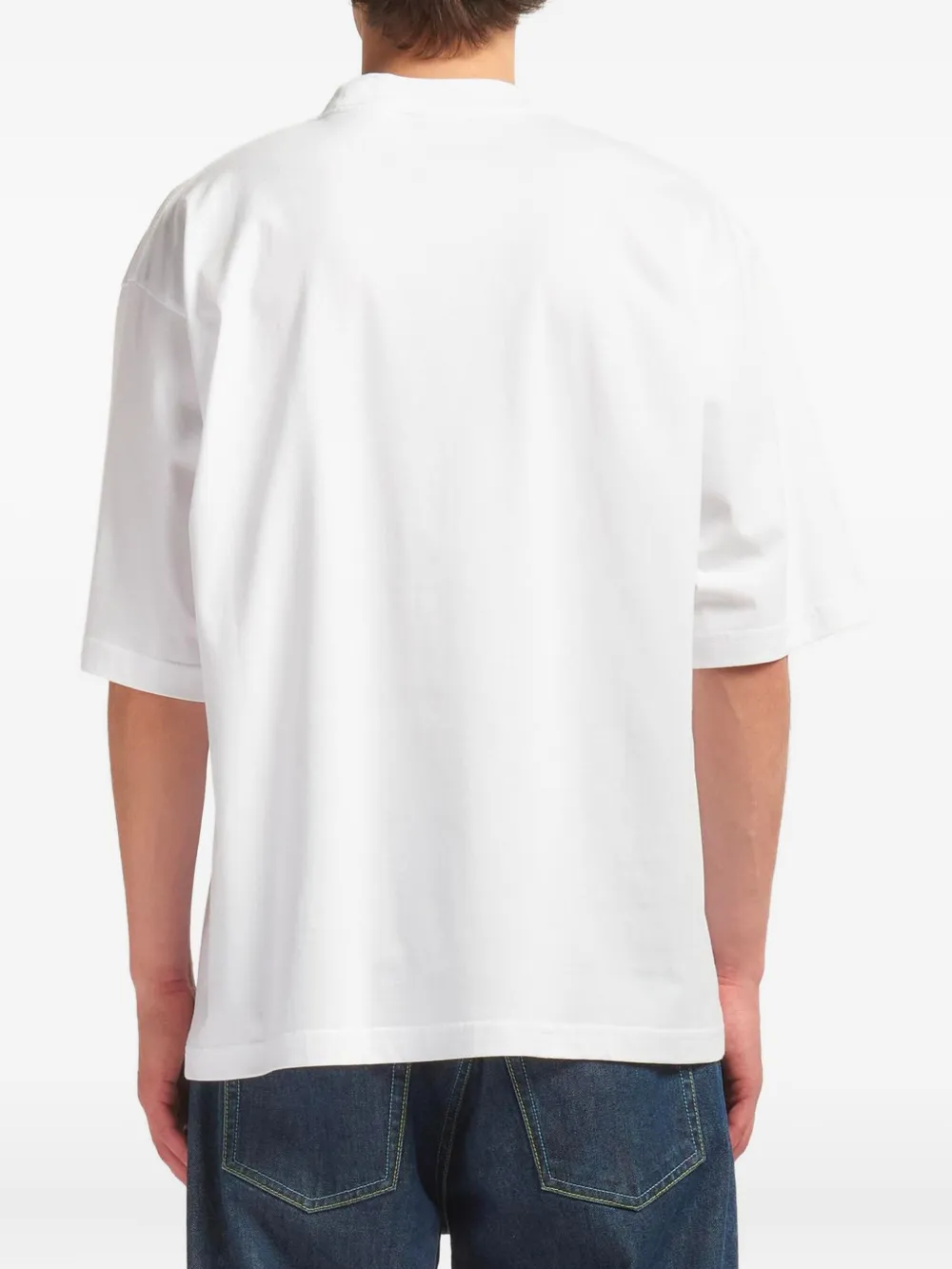 white t-shirt worn by a person, showing the t-shirt fit