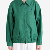 Green jacket worn by a person, showing the jacket fit