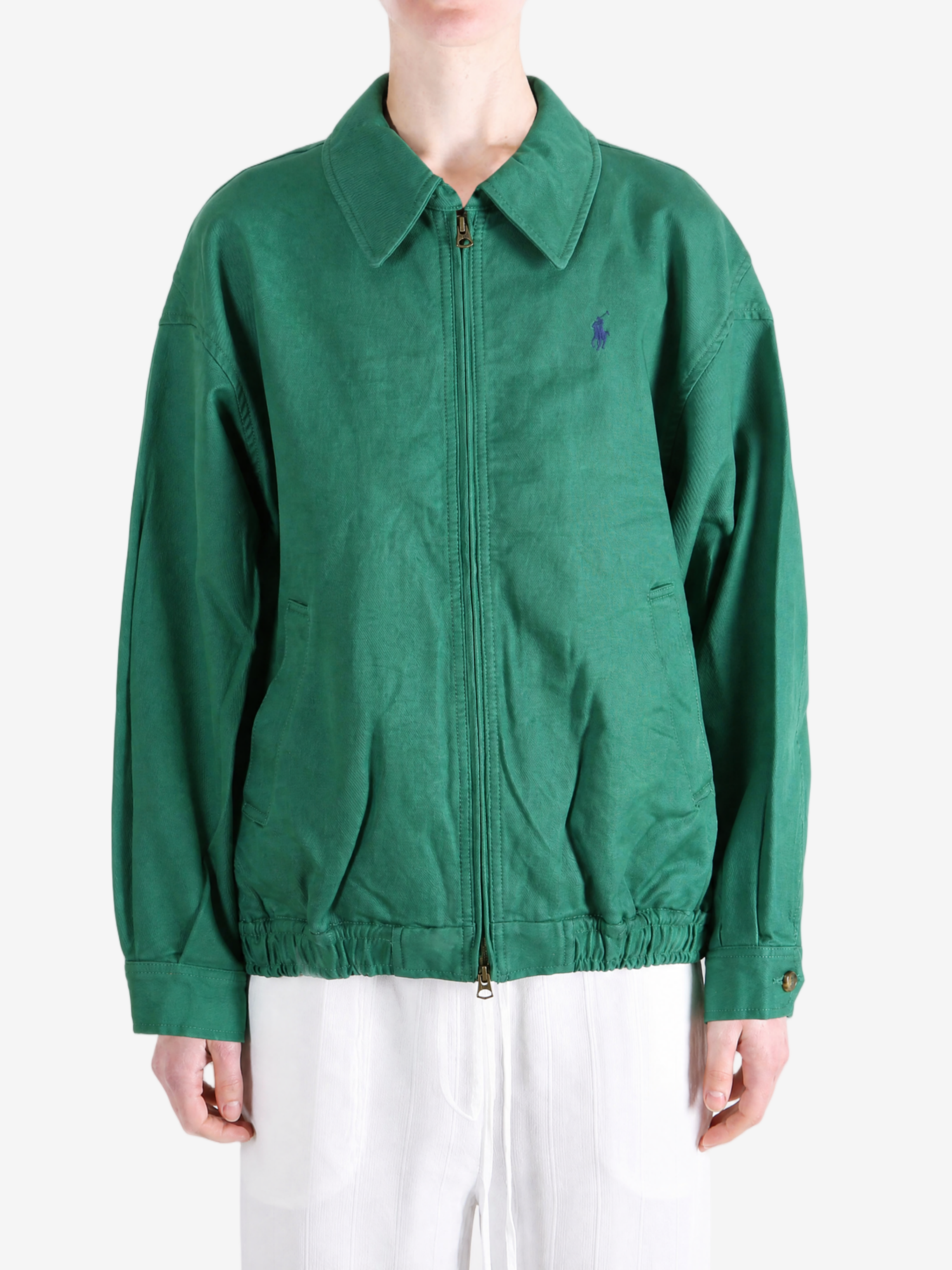 Green jacket worn by a person, showing the jacket fit