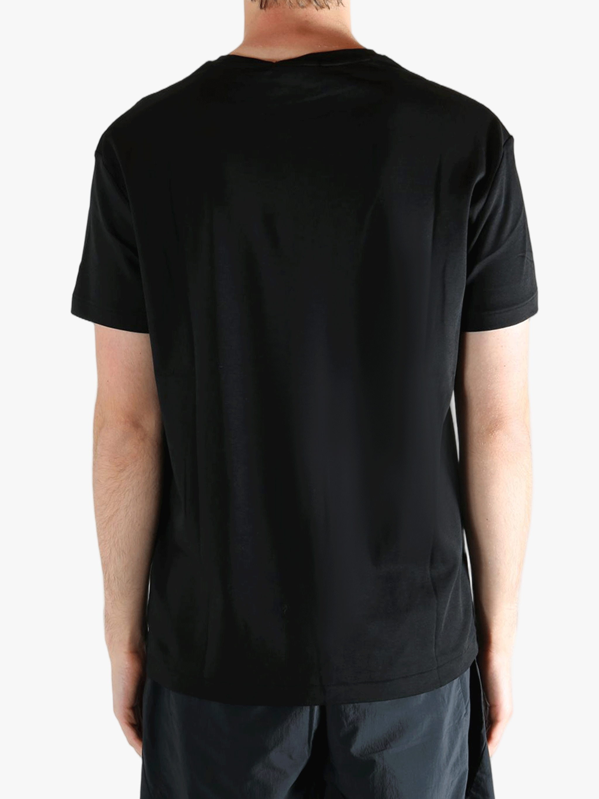 Black t-shirts worn by a person, showing the t-shirts fit