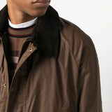 Brown jacket worn by a person, showing the jacket fit