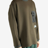 Brown pullover worn by a person, showing the pullover 's fit