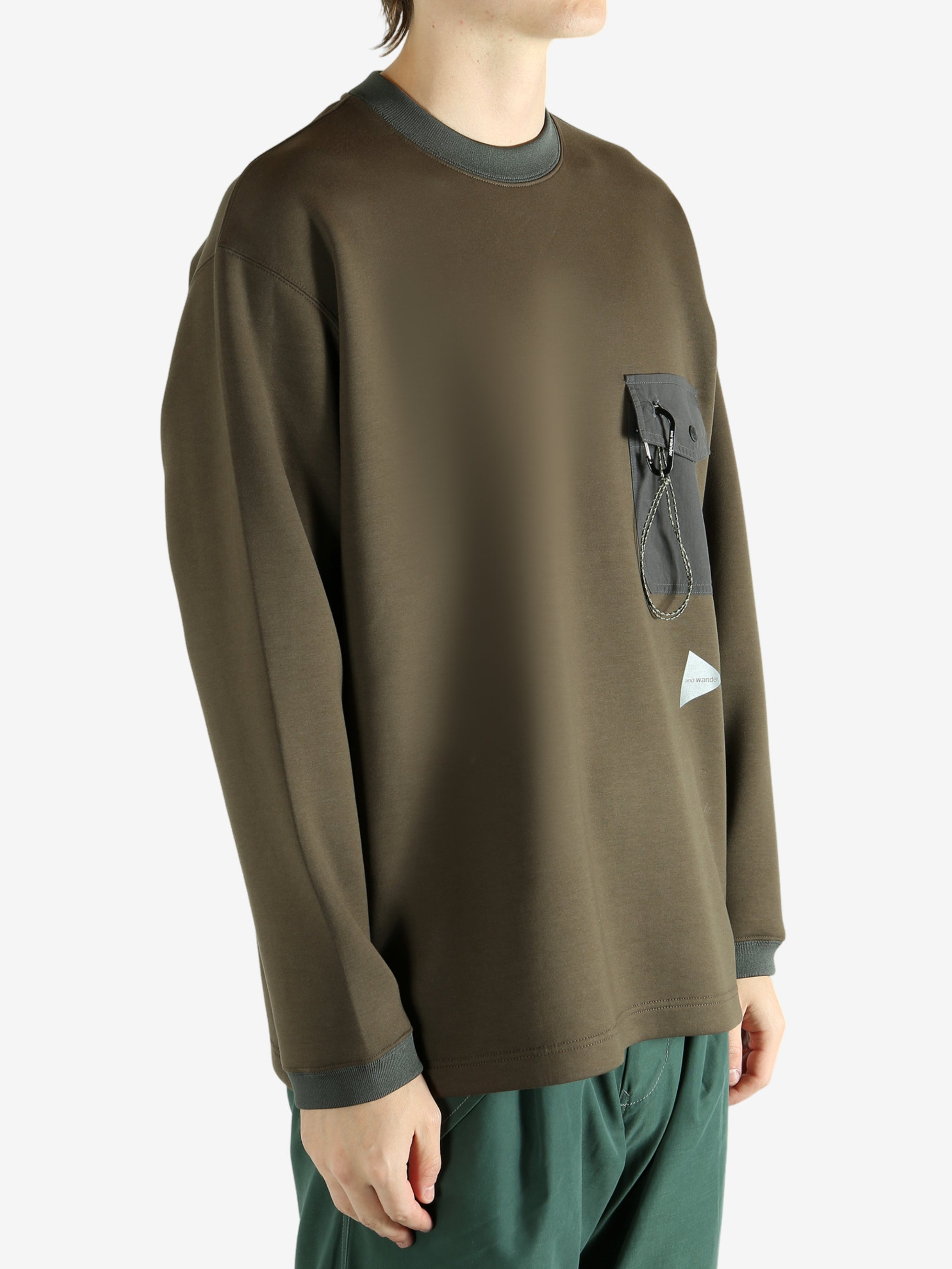 Brown pullover worn by a person, showing the pullover 's fit