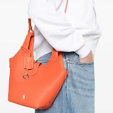 Orange bag worn by a person, showing the bag'fit