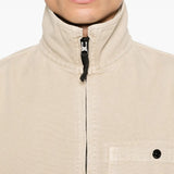 Close up of tan shirts, showing texture of the cotton fabric