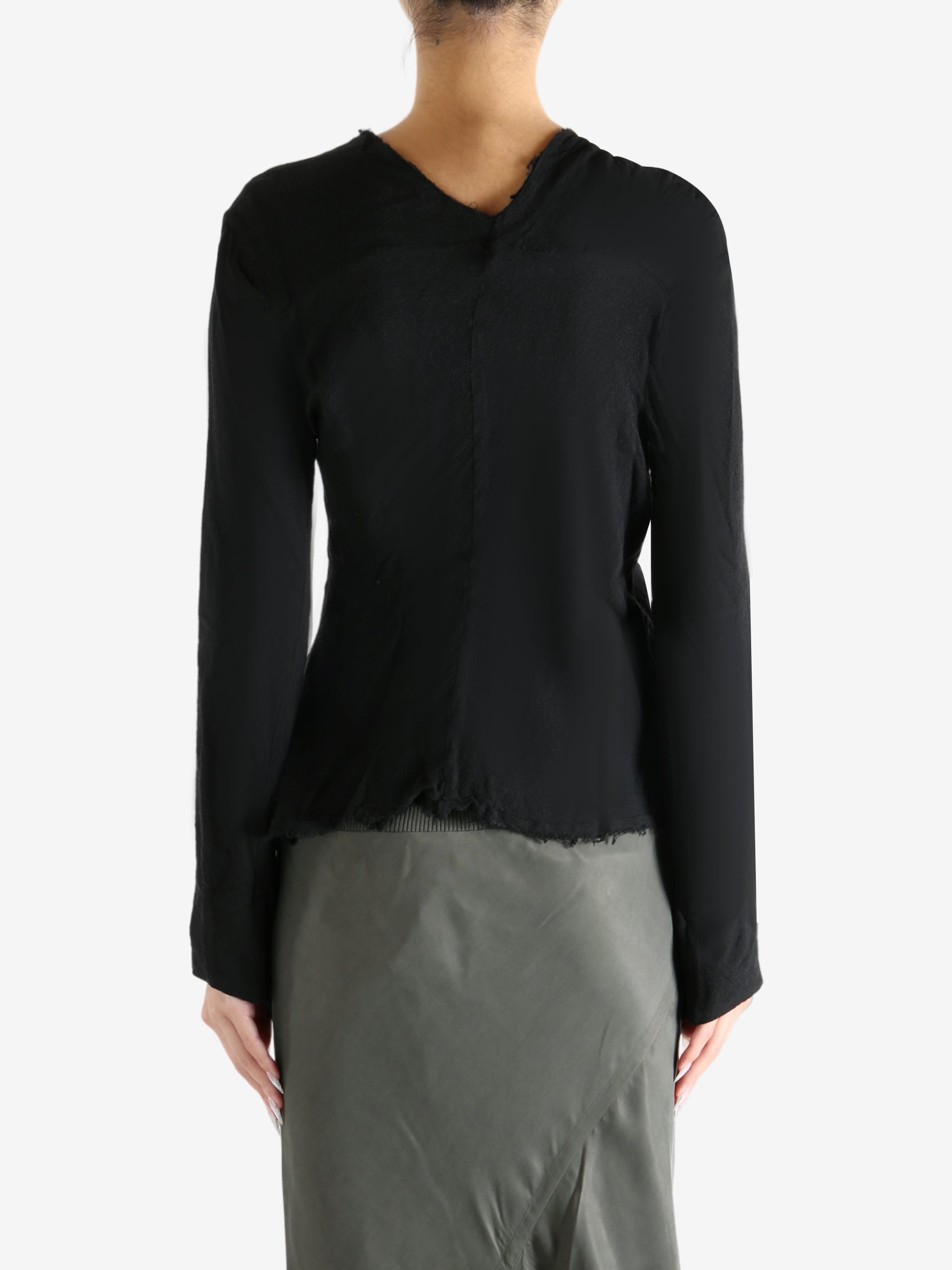 Black top worn by a person, showing the top's fit