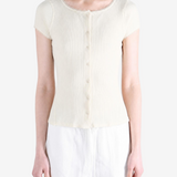 Tan knitwear worn by a person, showing the knitwear fit