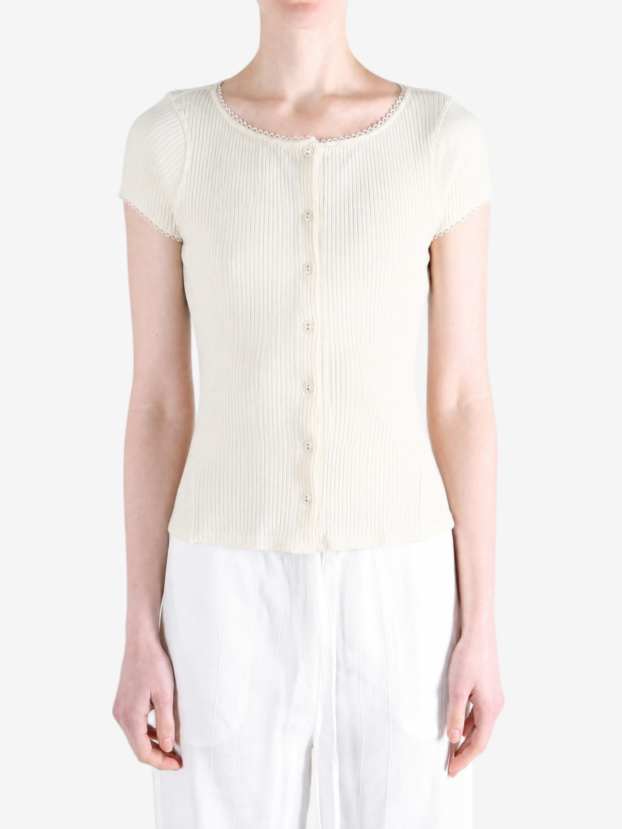 Tan knitwear worn by a person, showing the knitwear fit