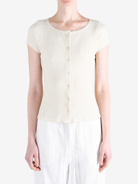 Tan knitwear worn by a person, showing the knitwear fit