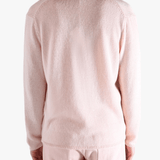 Light pink sweater,worn by a person, showing the sweater fit