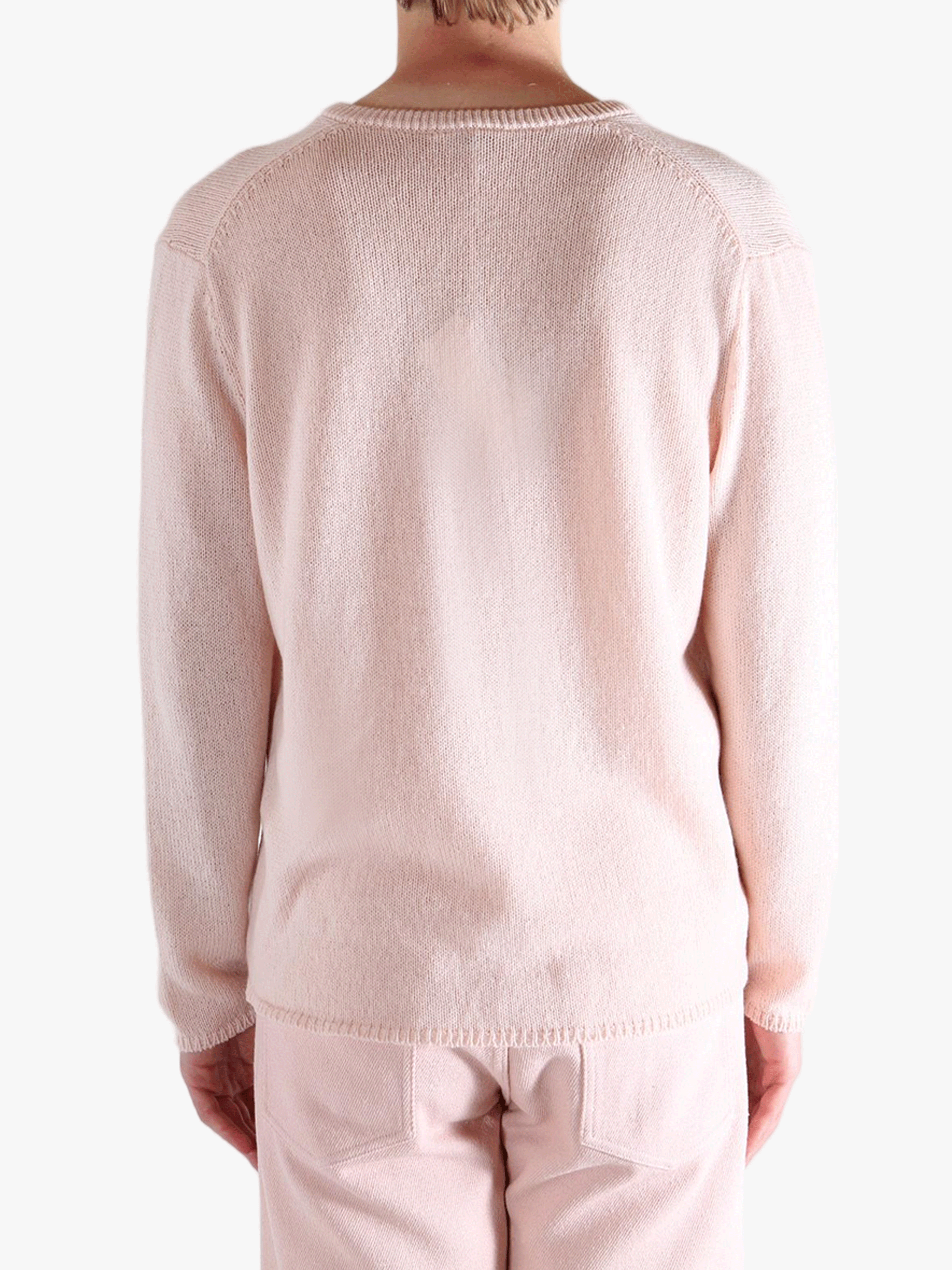 Light pink sweater,worn by a person, showing the sweater fit