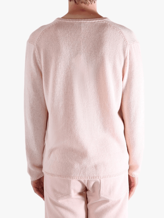 Light pink sweater,worn by a person, showing the sweater fit