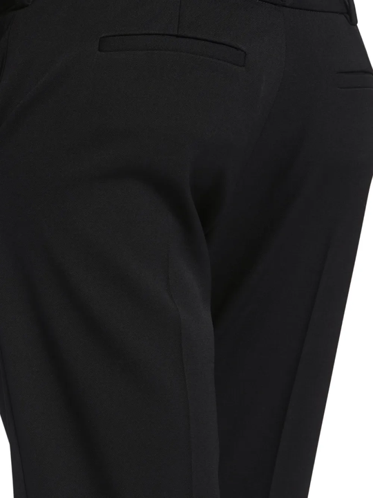 Close up of black pant, showing texture of the wool fabric