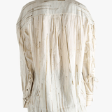 Tan shirt worn by a person, showing the shirt's fit