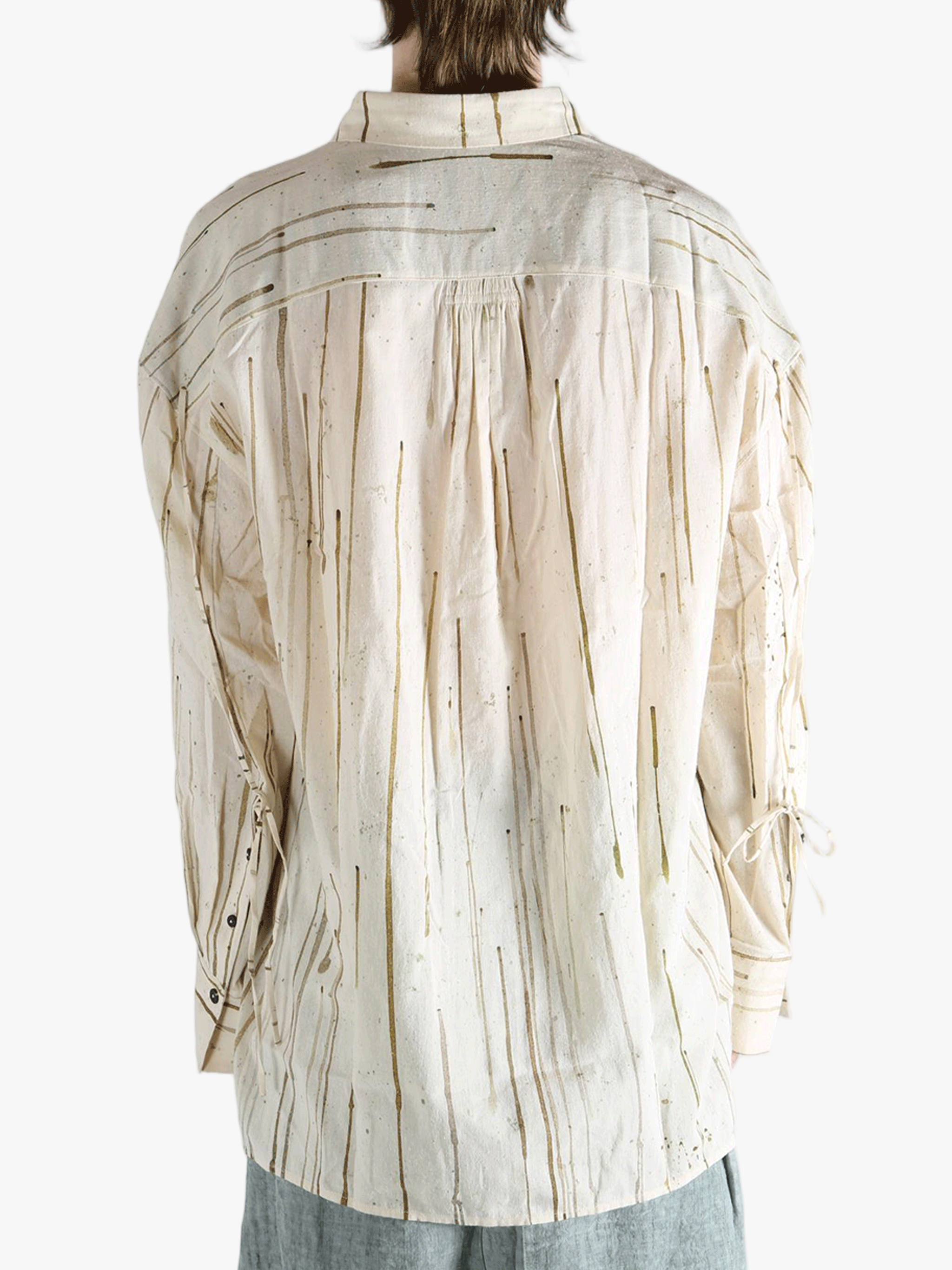 Tan shirt worn by a person, showing the shirt's fit