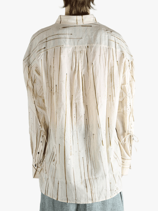 Tan shirt worn by a person, showing the shirt's fit