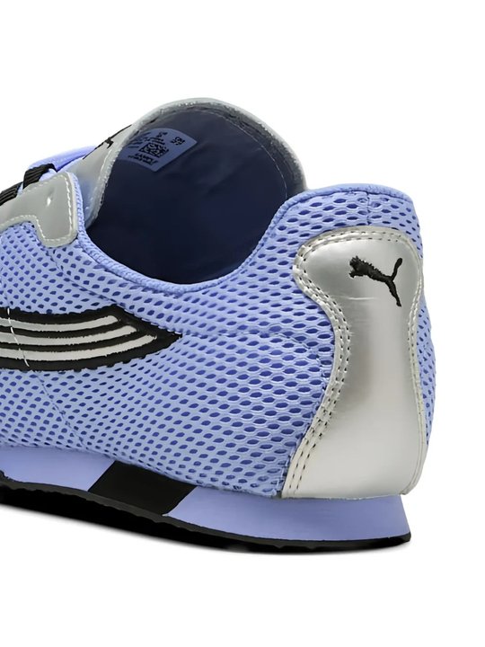 close up of blue sneakers, showing texture of the polyester fabric