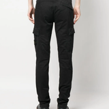 Black pants worn by a person, showing the black pants' fit