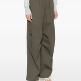 green pants worn by a person, showing the pants fit