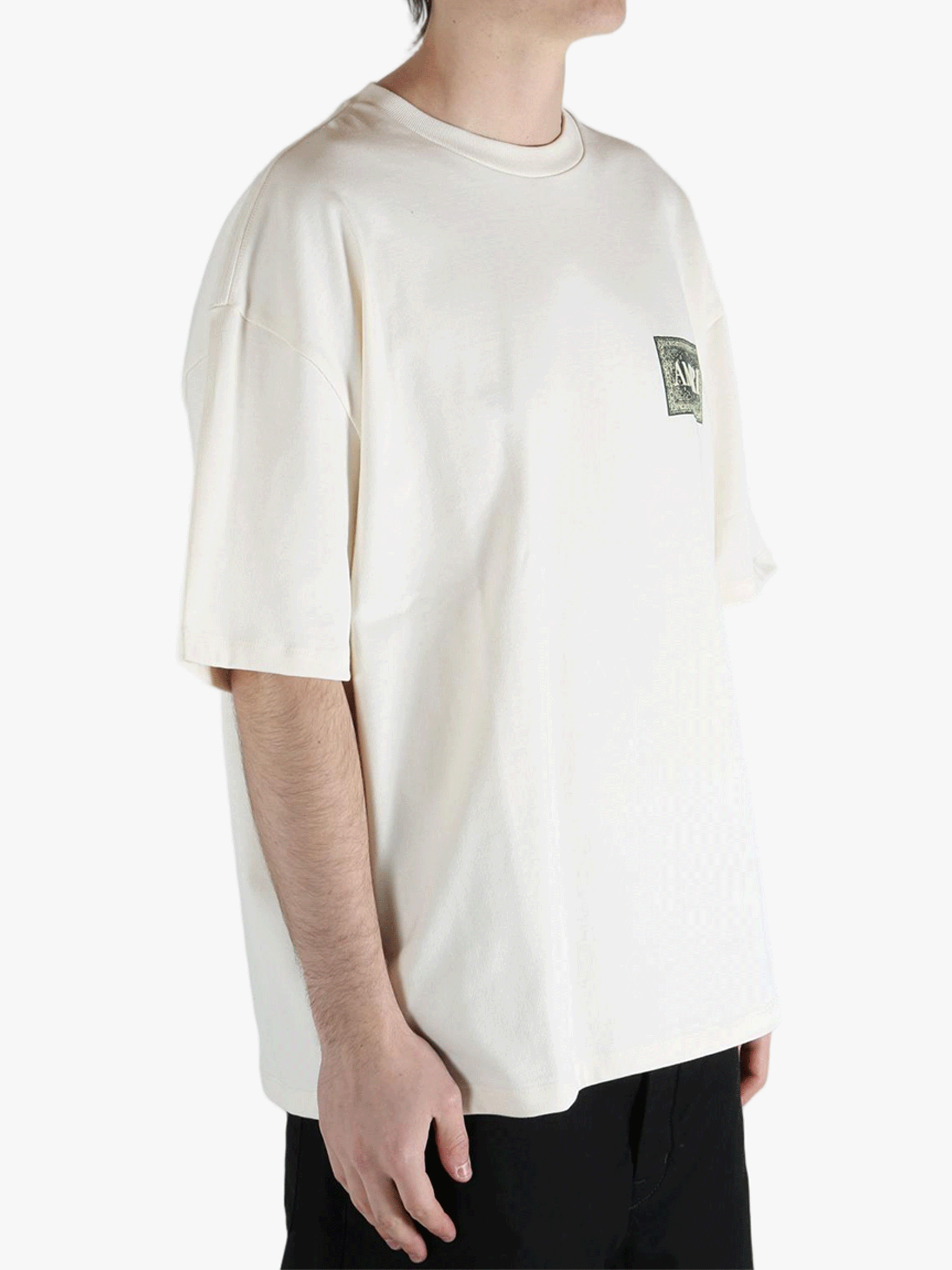 White t-shirt worn by a person, showing the t-shirt's fit
