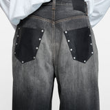 Black jeans worn by a person, showing the jeans fit