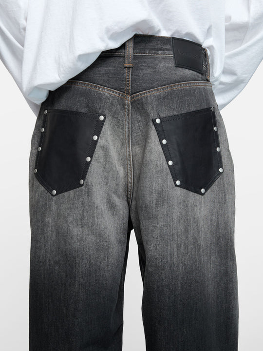Black jeans worn by a person, showing the jeans fit