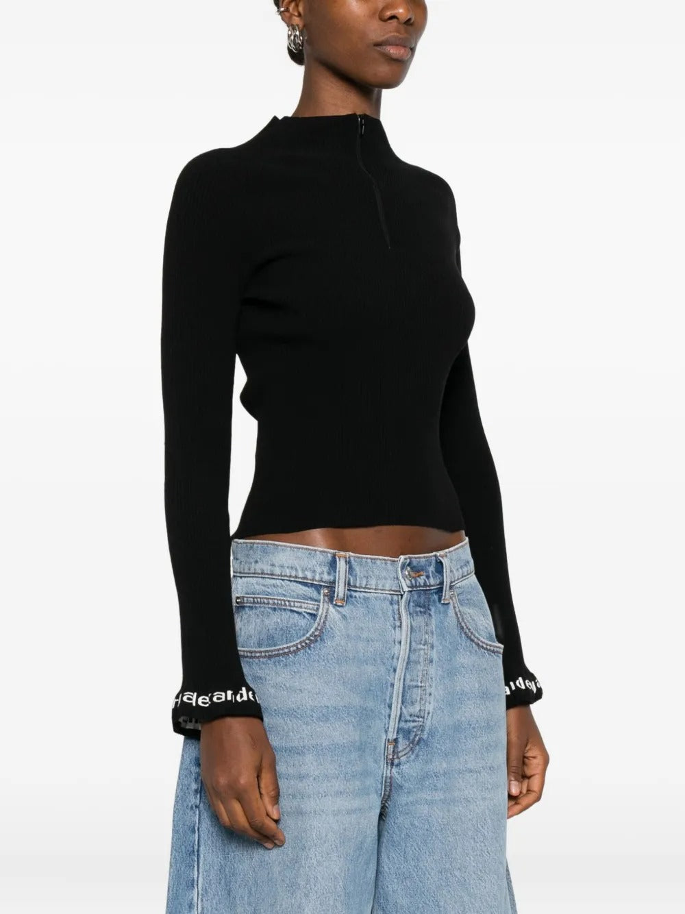 Black pullover worn by a person, showing the pullover's fit