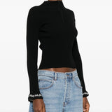 Black pullover worn by a person, showing the pullover's fit