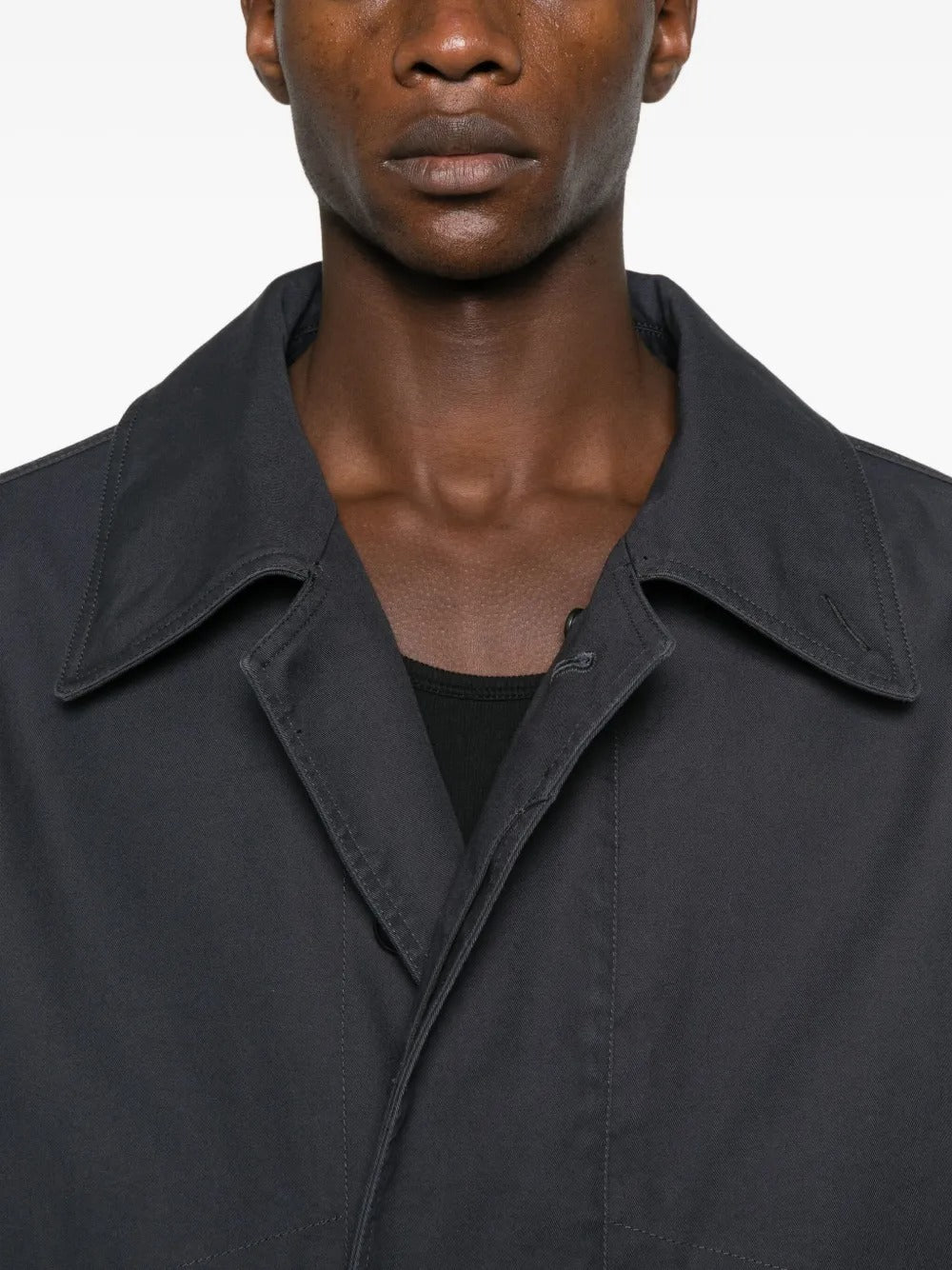 Close up of black coat, showing texture of the cotton fabric