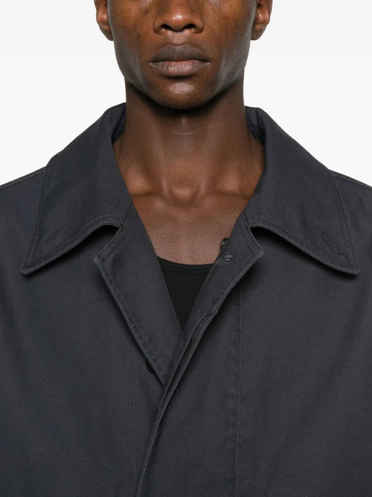 Close up of black coat, showing texture of the cotton fabric