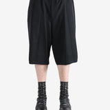 Black pants worn by a person, showing the pants's fit