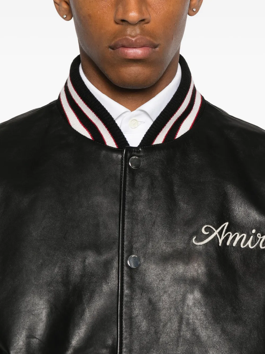 Close up of black jacket, showing texture of the leather fabric